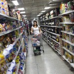 Woman in supermarket with shopping trollwy
