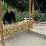 person placing a strawbale